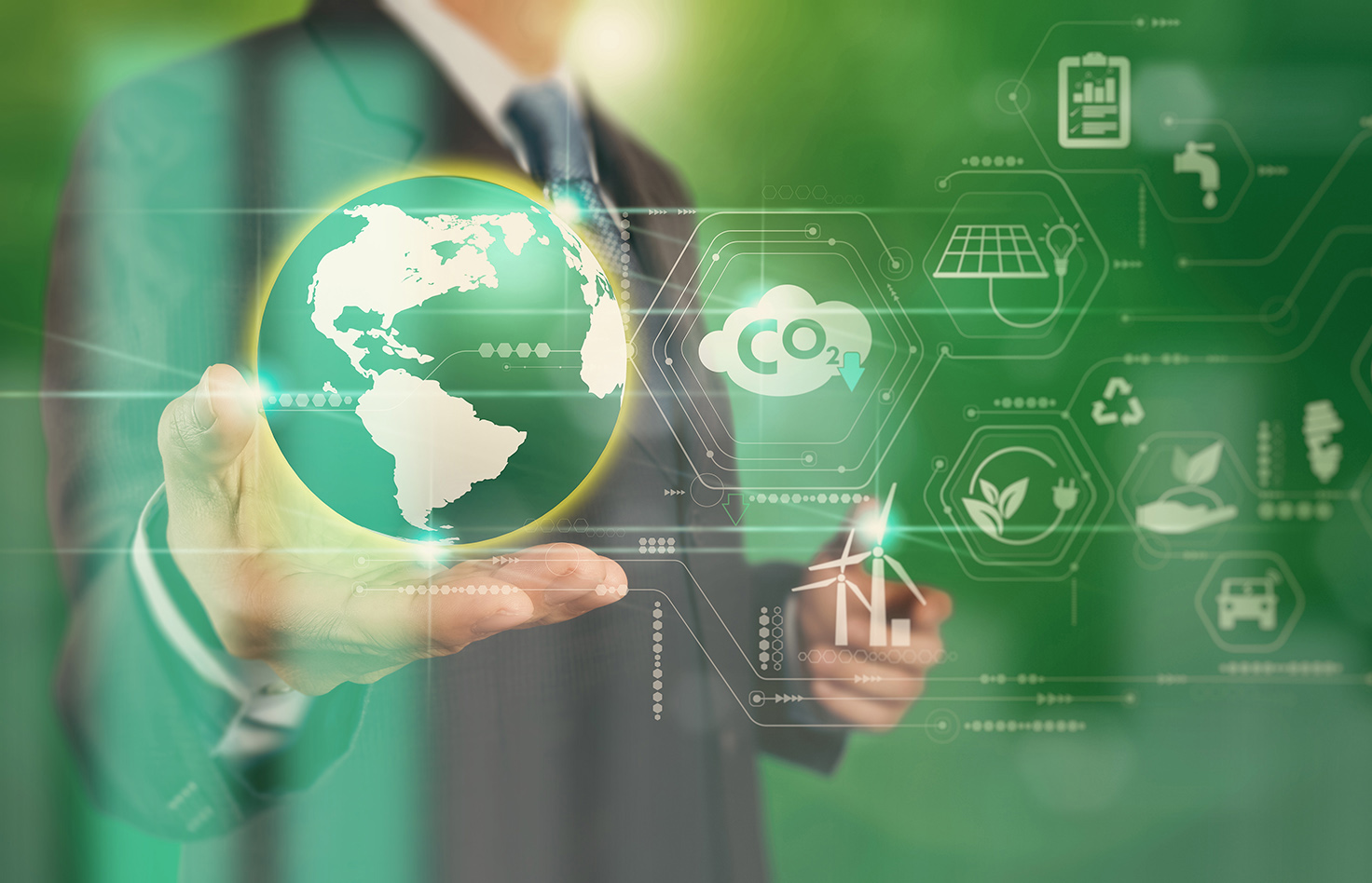 Businessman working virtual globe modern computer to reduce CO2 emissions carbon footprint climate change to limit global warming.